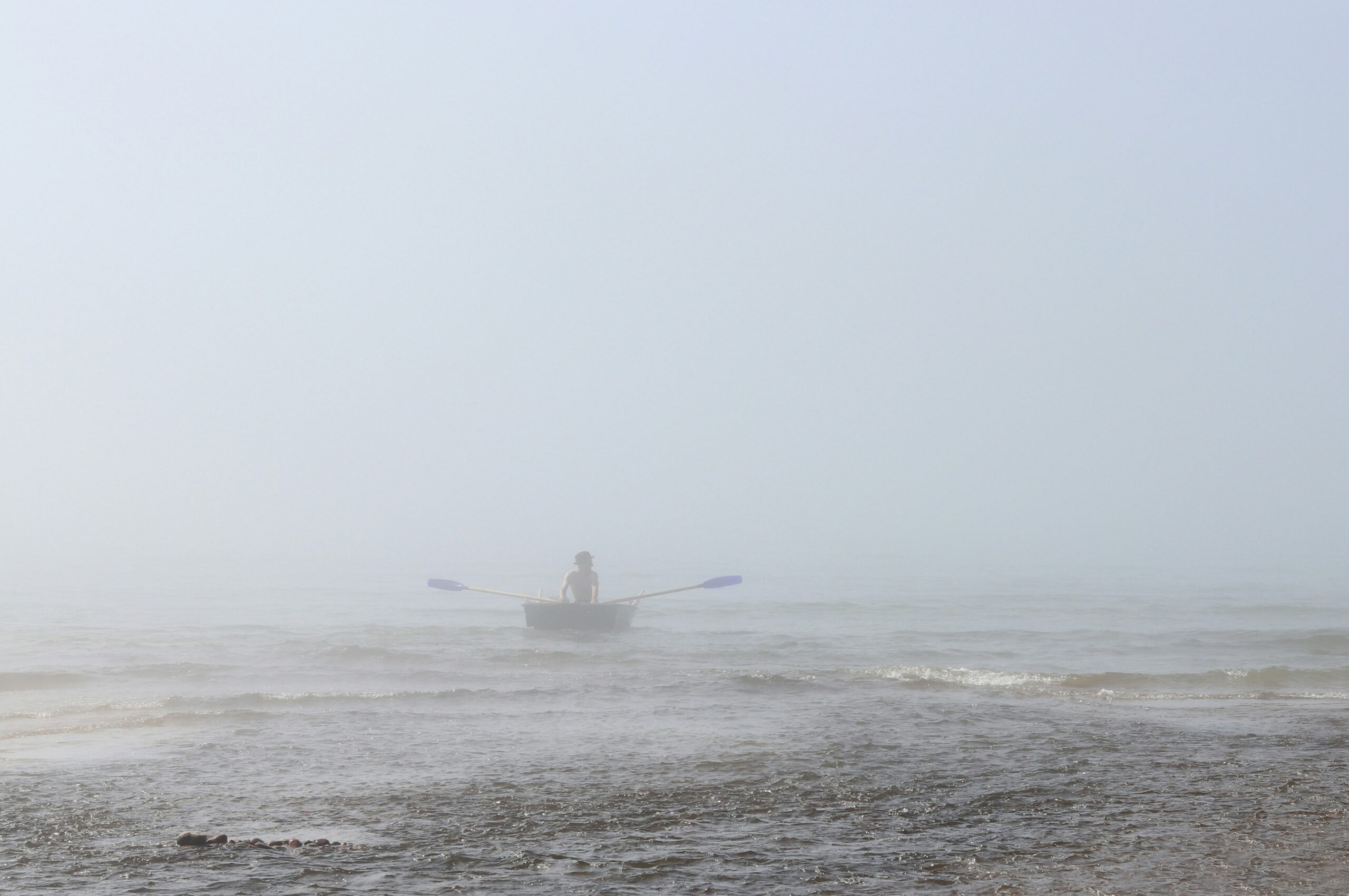 Yacht sailing on calm blue waters under a clear sky, representing yacht charter insurance expertise